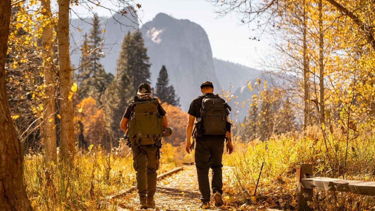 Two hikers exploring the fall colors in the Black Hills